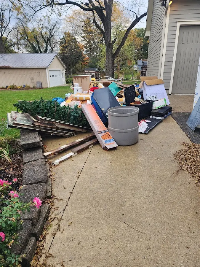 Dumpster being loaded with debris for Estate Cleanout Dumpster Rental in Manlius